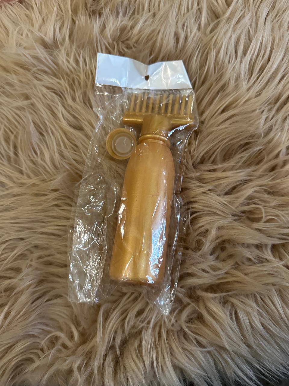 Hair oil bottle with comb