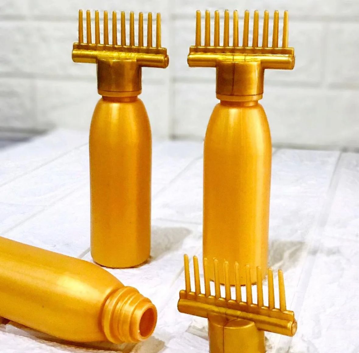 Hair oil bottle with comb